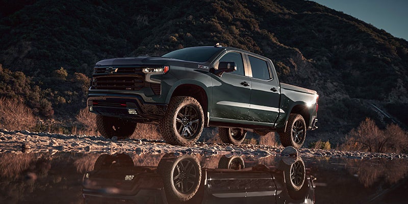 Blue 2025 Chevrolet Silverado 1500 parked on rugged terrain near Victoria, TX